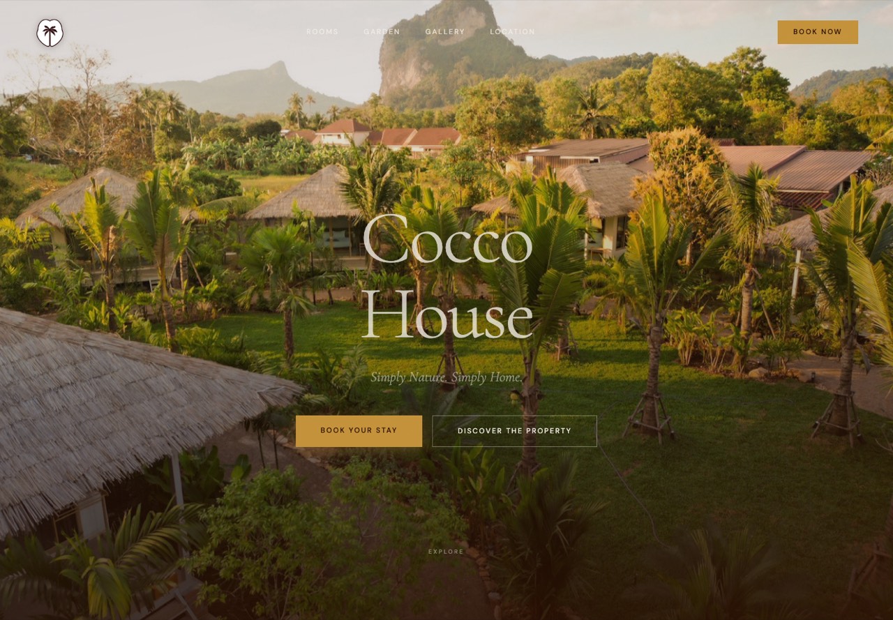 The Cocco House landing page: thatched garden bungalows among palms at golden hour, below a limestone karst, with the name set large over the lawn.