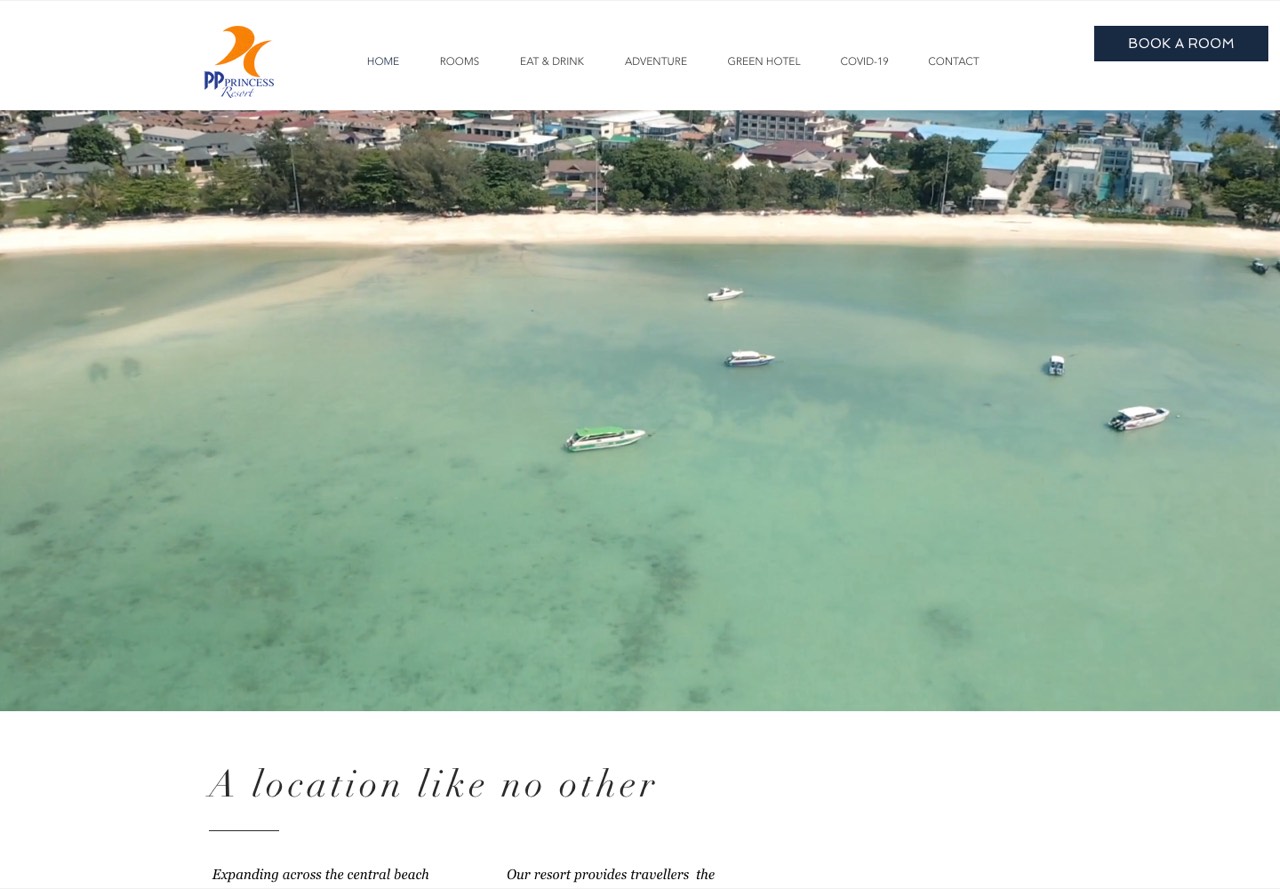 The PP Princess site: the resort&rsquo;s navigation and a &ldquo;Book a Room&rdquo; button over a full-bleed aerial of the turquoise bay off Phi Phi Island, headlined &ldquo;A location like no other.&rdquo;